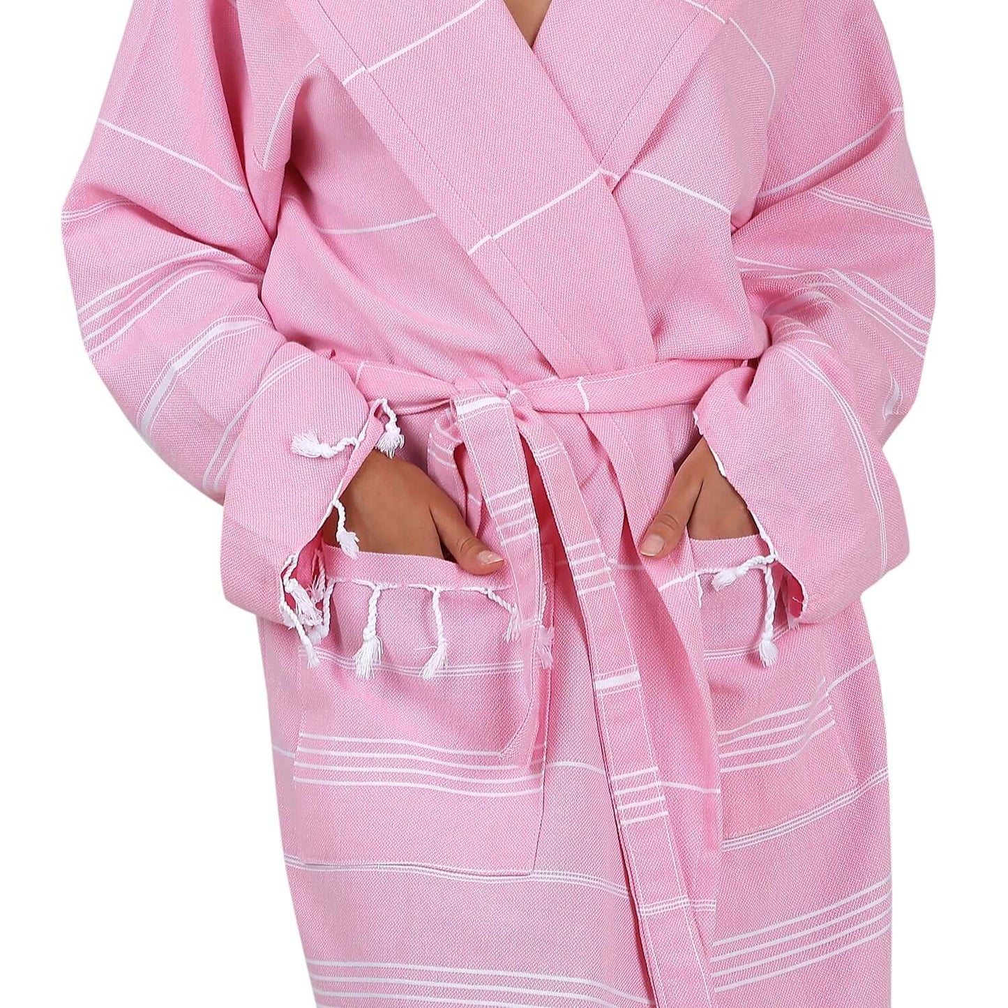 Close-up view of the Loom Legacy xsmall/small pink bathrobe, highlighting the intricate white stripe pattern, the tie belt, and the fringe detailing on the pockets