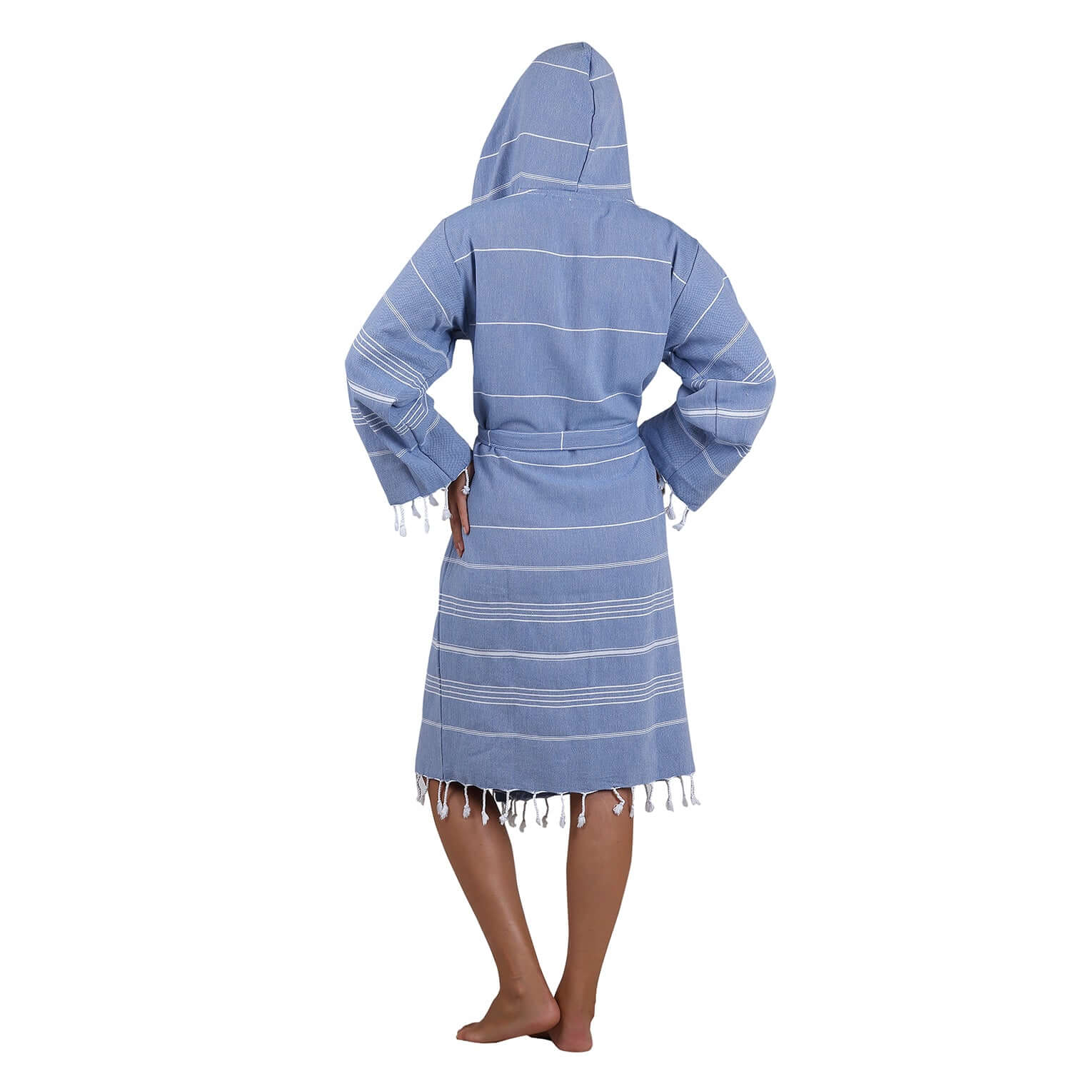Rear view of the man wearing Loom Legacy xsmall/small blue bathrobe showcasing the hood, white stripe pattern, and fringe detailing at the bottom.